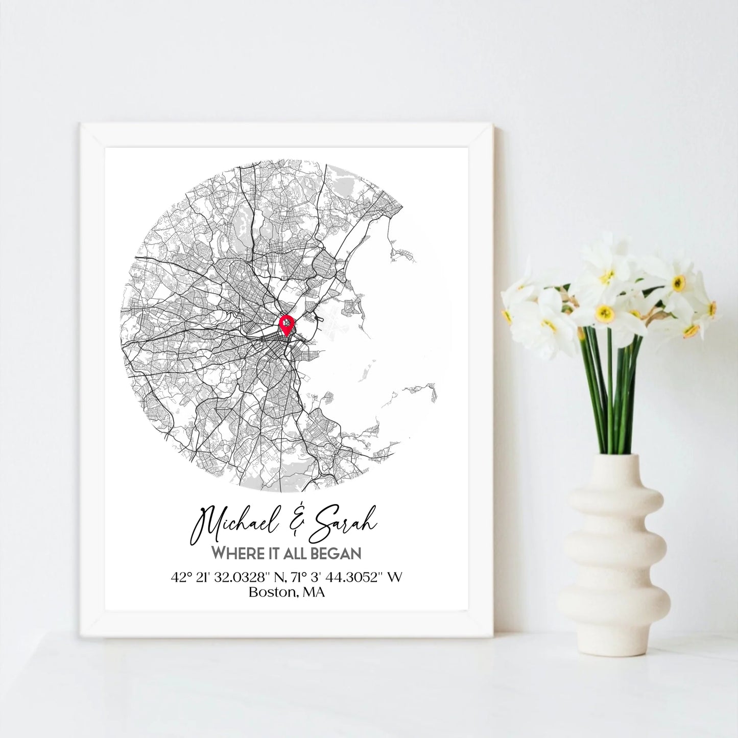 Where We Met Map Gift with an 11x14 inch white frame, showing a city map with a red pin marking a location, personalized with the names 'Michael & Sarah' and coordinates for Boston, MA.