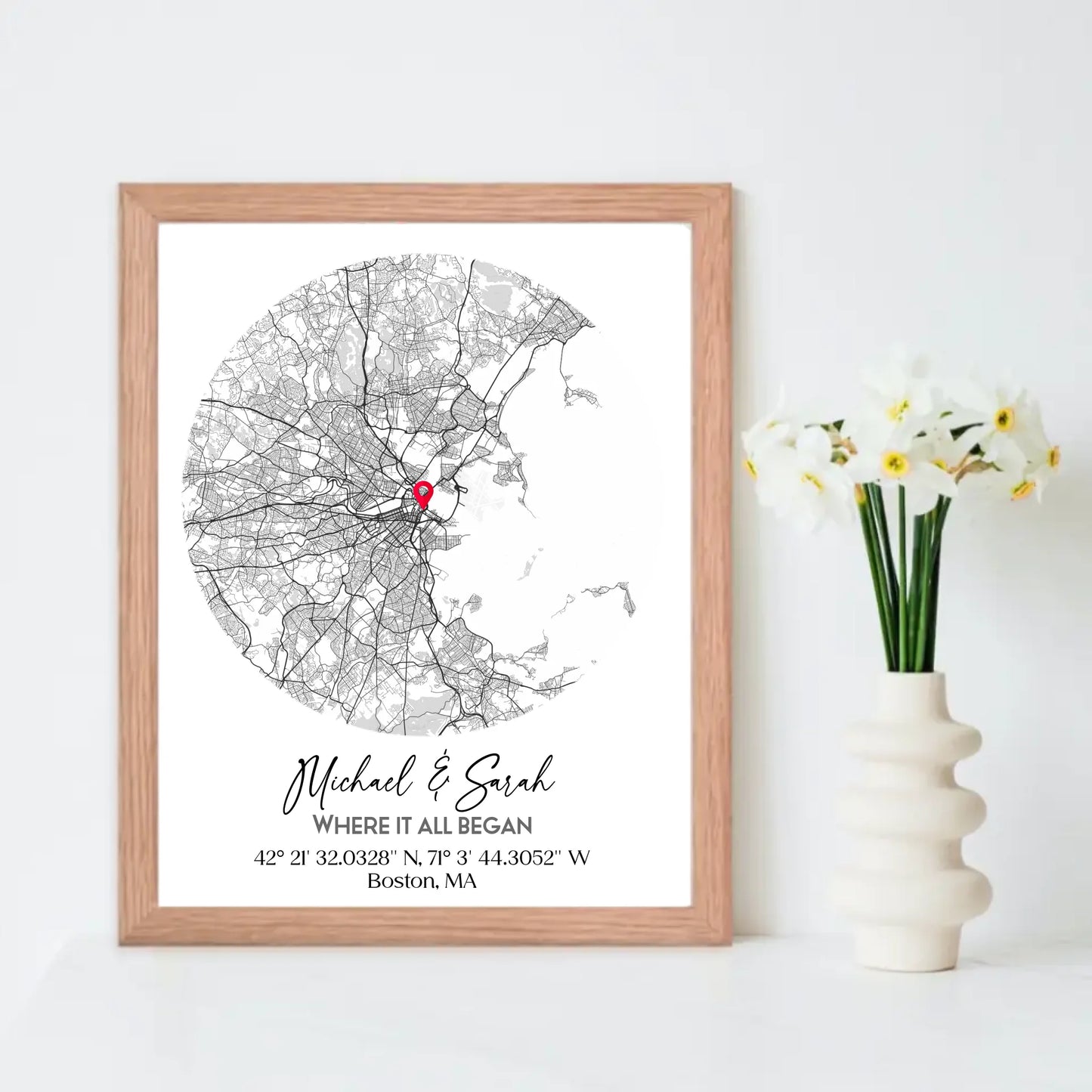Where We Met Map Gift with a 16x20 inch red oak frame, showing a city map with a red pin marking a location, personalized with the names 'Michael & Sarah' and coordinates for Boston, MA.