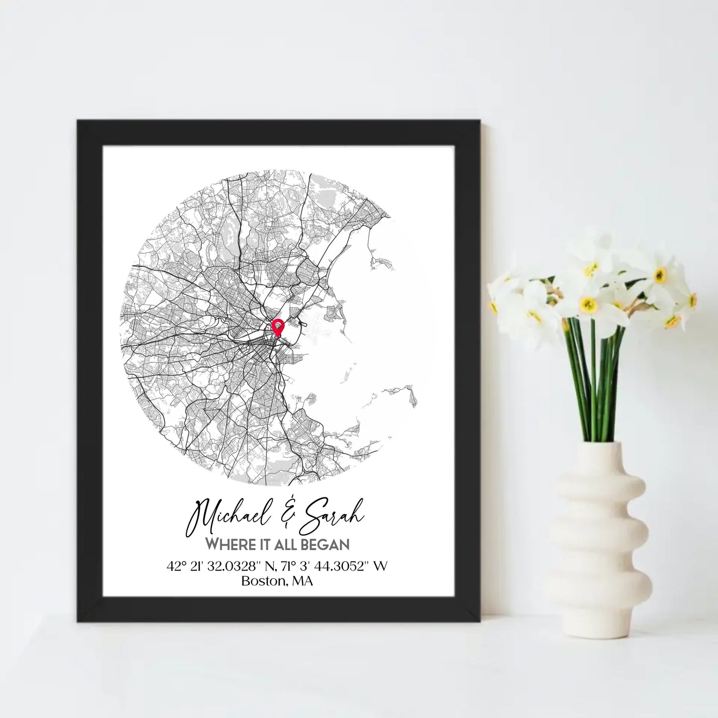 Where We Met Map Gift with a 16x20 inch black frame, showing a city map with a red pin marking a location, personalized with the names 'Michael & Sarah' and coordinates for Boston, MA.