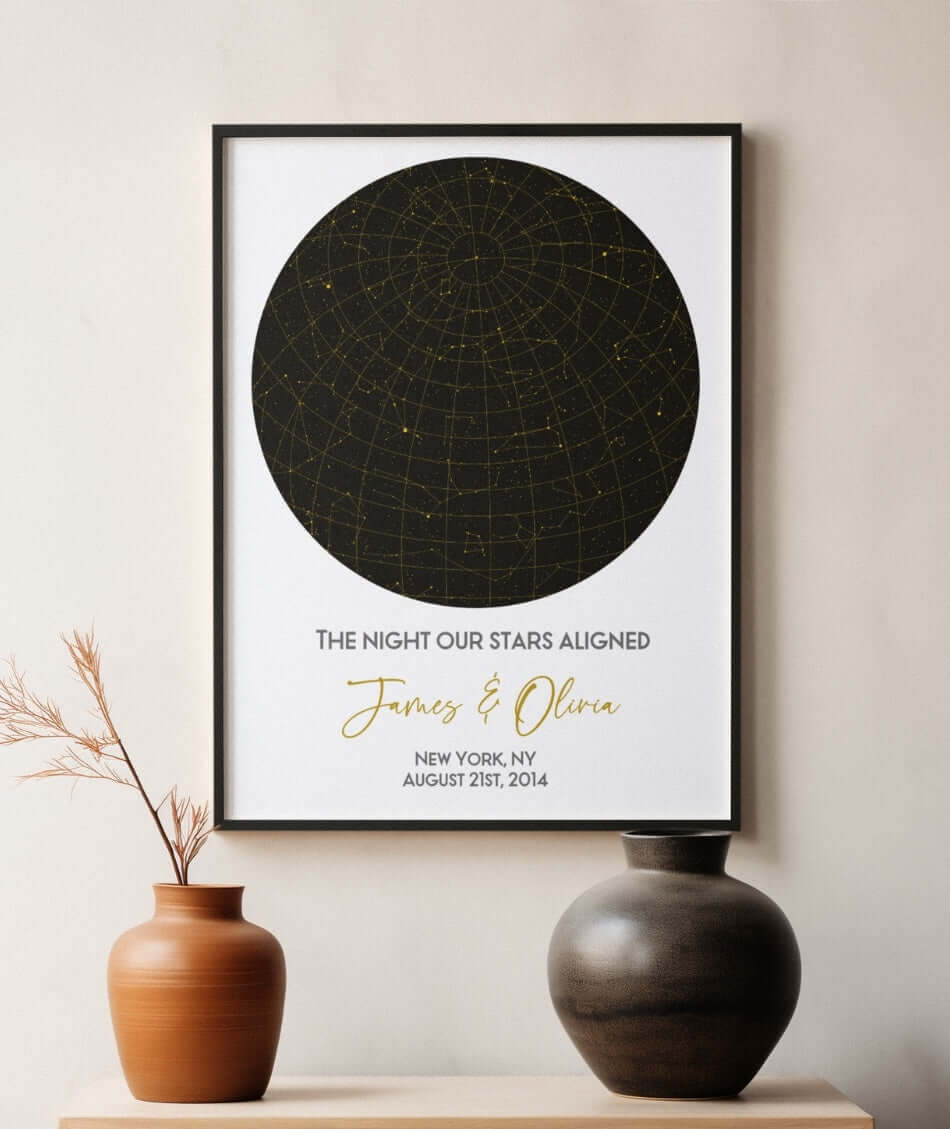 A framed star map titled "THE NIGHT OUR STARS ALIGNED" is displayed on a wall. Below the title are the names "James & Olivia" written in a gold cursive font. The star map features a black circular sky chart with golden star constellations.