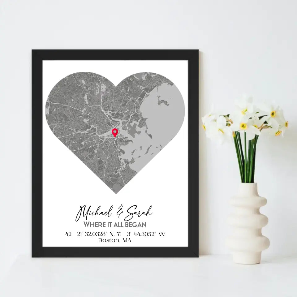 Where We Met Map Gift with an 11x14 inch black frame, showing a city map with a red pin marking a location, personalized with the names 'Michael & Sarah' and coordinates for Boston, MA.