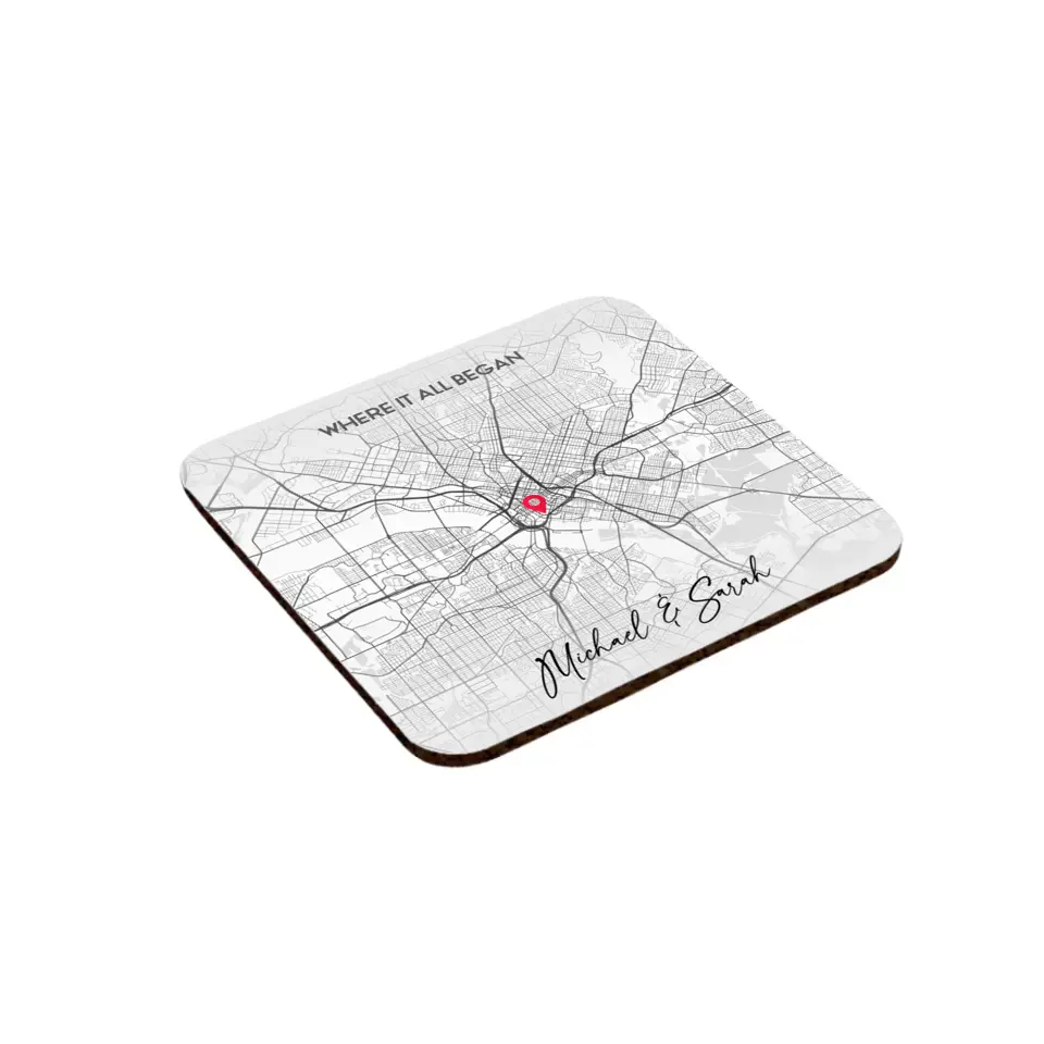 Side view of personalized coasters featuring a city map design with a red location pin, customized with specific locations, your names, and titles.