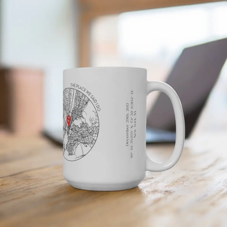 Right side of 15oz anniversary mug featuring a city map design with a red location pin, personalized with title, coordinates, date, and place.